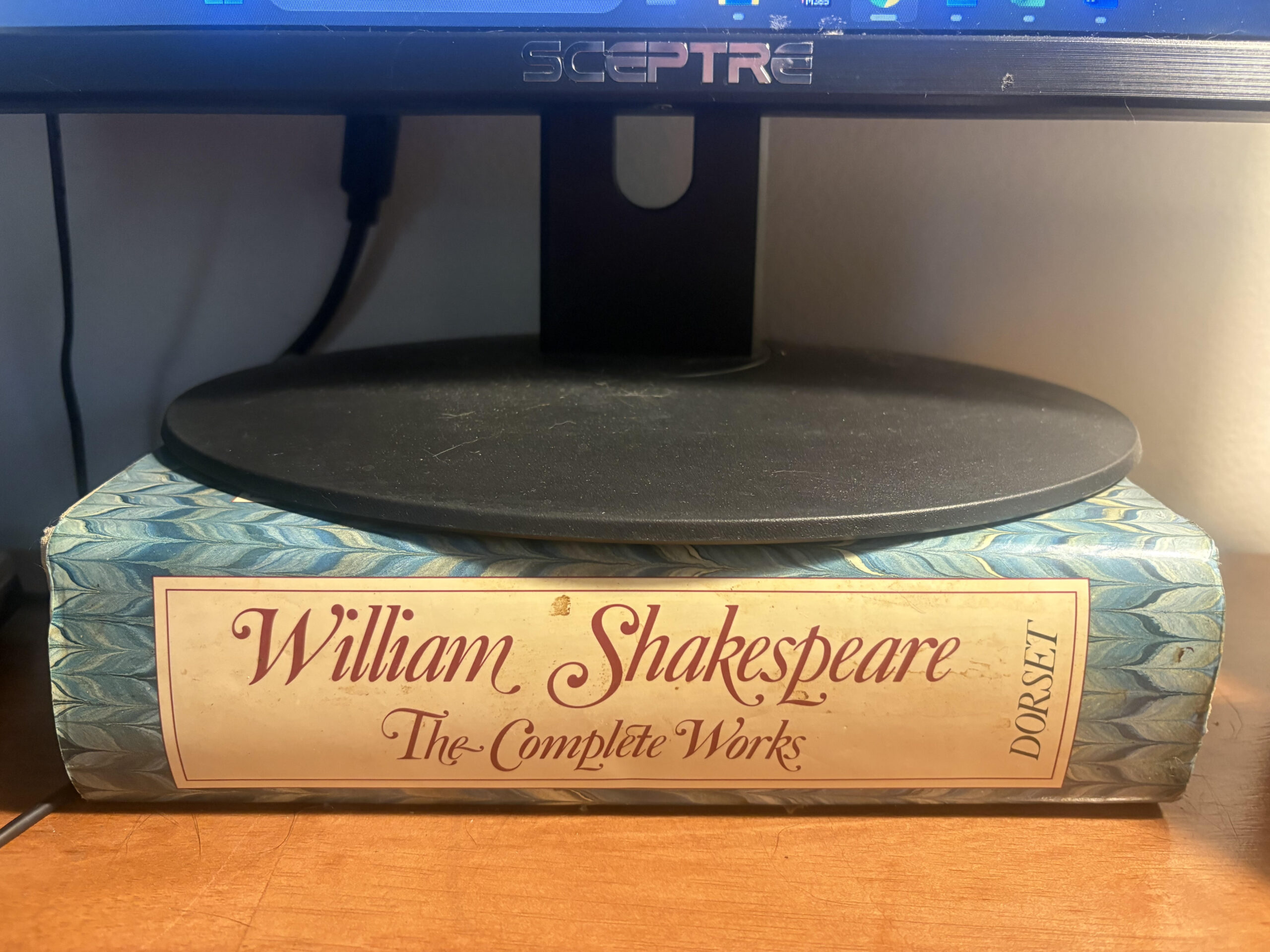 A photo of the Collected Works of William Shakespeare holding up my computer monitor
